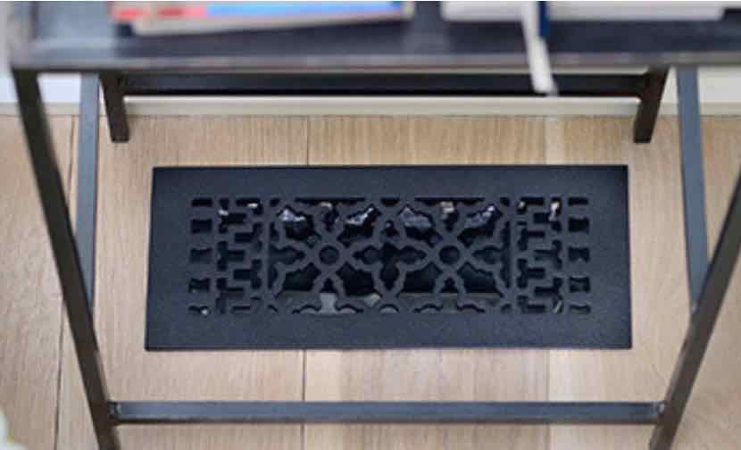 decorative black floor grille under a side table